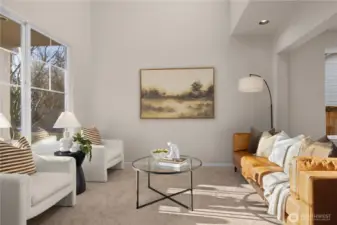 Spacious 2-story living room with skylights and tall windows brings in tons of natural light