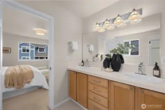 Upper level primary bathroom has a large 2-sink vanity.