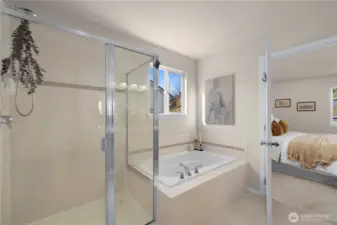 The spa-like primary bathroom has a deep soaking tub and separate shower.