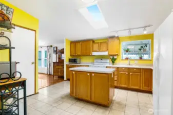 The kitchen is such a bright room to be in, with the skylight and the plant/greenhouse window that holds about six plants.