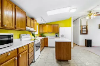 The kitchen comes with all the appliances, and you'll enjoy the island that has extra cabinet space, and the easy-to-clean vinyl tile flooring.