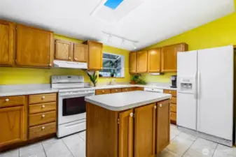 Another view of the kitchen with those appliances, especially the large refrigerator!