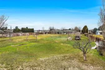 The back yard is surrounded by a six-foot wooden fence.