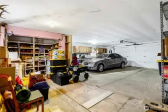 This two-car garage has its own unique concrete cellar with a hinged wooden door in the floor.  Notice the large open pantry to the left, for all your canned goods.