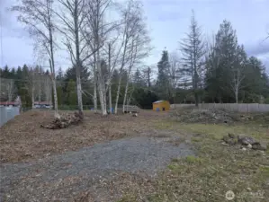 Inside the gate by the driveway facing north.