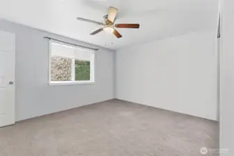 Primary bedroom has been virtually decluttered to remove moving boxes.