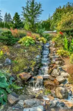 The spectacular, cascading waterfall--so lovely--adds to the park-like ambiance of this yard