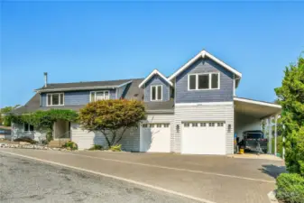 The garage has an epoxy floor, Tesla charger, very tall ceilings and wide/tall doors.  Note the 2 car covered carport witch already has an RV pedestal installed!