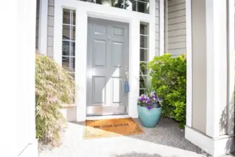 Vaulted Exterior Entry with Lush Plants.