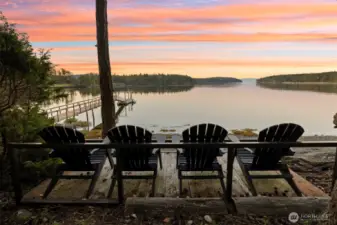 A private shoreline perch  overlooks tranquil waters and your shared dock. Watch eagles soar and boats drift by as you take in panoramic island views stretching across the San Juans all the way to the Olympic Mountains.