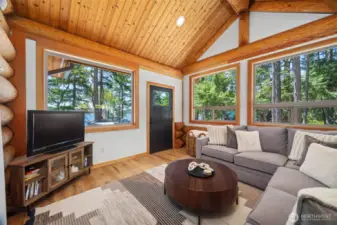 Wrapped in windows with serene ocean views, this secondary living space offers a quiet escape—ideal for movie nights or peaceful mornings on the coast.