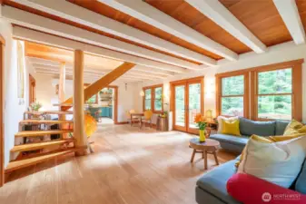 Raw edge wooden stairs and posts all milled from trees from the property along with most shelving in the home.