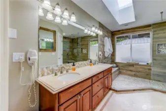 Large bath with custom  walk in shower. Shower has heated floor.