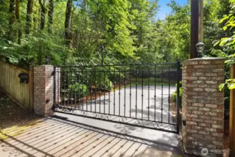 Beautiful entrance with automatic gate and lush grounds.