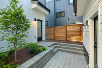This is the courtyard area between the detached home and the carriage house. The door on the right takes you into the main living room of the detached home. The door on the left is the back entrance to the carriage house.