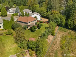Property extends beyond wood fence to the green chain link fence.