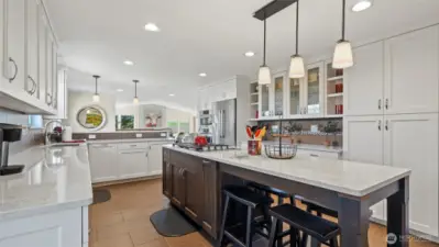 There is loads of cabinet space including elegant open glass cabinets for barware and a large floor to ceiling pantry. This remodel was incredibly thoughtful and intentional.