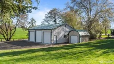 The 1300 s.f. shop with oversized bays has an RV pad on the north side. The garden shed has a roll up door and cement floor.