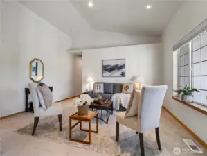 The living room has vaulted ceilings and architectural details to welcome you in.