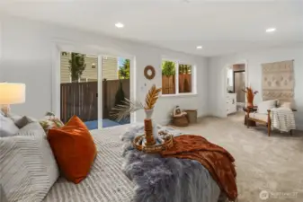 Lower Level Suite: Expansive lower-level suite features plush carpeting, sliding glass doors to the backyard, and large windows that fill the room with natural light. This versatile retreat works beautifully as a private guest suite, multi-generational space, or flexible bonus room.  Staged photos are of the model home of the same floorplan within the Foxmoore community and are for visualization purposes only. Colors, finishes, and layout can and will vary.