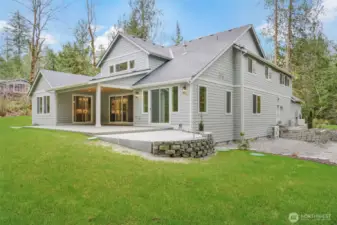Rear of home with freshly poured concrete hot tub pad with electrical ready to go
