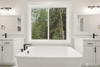 Large soaking tub with views into forest owned by St. Martins University