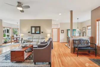 Living room flowing seamlessly toward the dining area. Breakfast nook to the left, and kitchen behind the wall