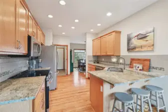 Functional kitchen layout with generous workspace and storage. Dining area conveniently located next to the kitchen.