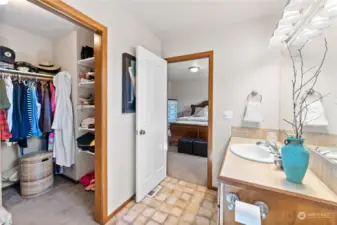 en suite closet and bath for primary bedroom