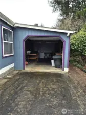 one car garage with electric door and storage