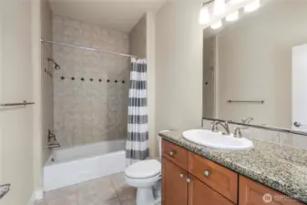 Bathroom has great appeal with the tiled shower and floor, and granite counter top.