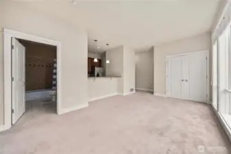 Living room view looking toward laundry, with entry around kitchen and to the right.