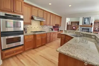 Stainless Steel Double oven, gas cooktop, slab granite and plenty of cabinets.