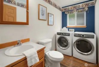 Half bathroom and laundry area off of the family room.