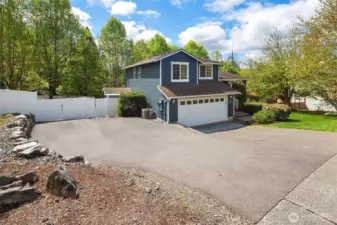Additional paved parking on the side of the home.