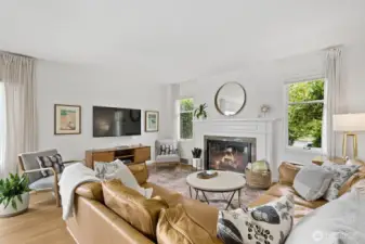 Cozy gas fireplace and lovely mantle center the room.