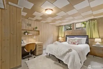 Non conforming carpeted bedroom with wide plank beautiful blonde wood paneling.