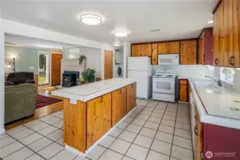Large kitchen with tile floors & counters.