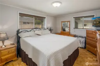 Primary bedroom has 2 closets & parquet flooring.