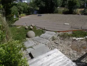 Nice perspective of the lot.  Here you see the small raised deck and North side of the lot where RV can go.