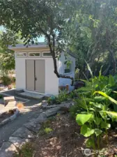 Custom shed with counter, cabinets and flooring is a versatile addition to this already amazing RV lot!