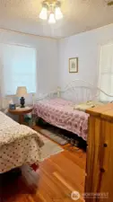 Bedroom with original hardwood floors.
