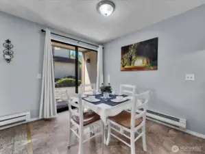 Dining room with new LED light, easy-care vinyl flooring, and access to the patio perfect for indoor/outdoor living.