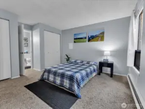 Renewed primary bedroom with new carpet and paint, connected to bathroom.