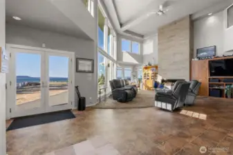 Soaring ceilings and wall to wall windows to welcome you home to this open floor design.  2 ceiling fans, gas fireplace and a heat pump maintain your comfort nicely
