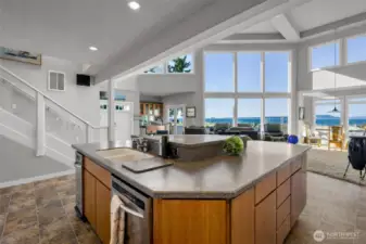 Generous sized kitchen island with stainless steel trash compactor, dishwasher with enamel sink- all within cherry cabinetry topped with solid surface countertops. Vinyl flooring for that easy beach-house maintenance.