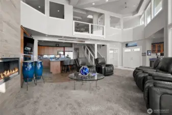 By design the home strategically placed interior windows on the upper floor bedrooms- providing more possibilities for views.  Kitchen is tucked in underneath and the entrance to the primary suite beyond the stairs