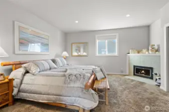 A spacious main-level primary suite with gorgeous corner fireplace