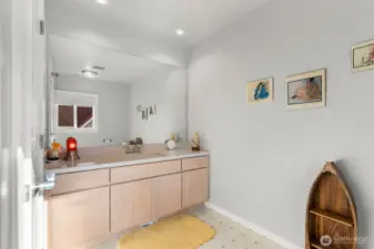 Second bedroom ensuite bathroom- cohesively built with the same cabinetry of the other bathrooms