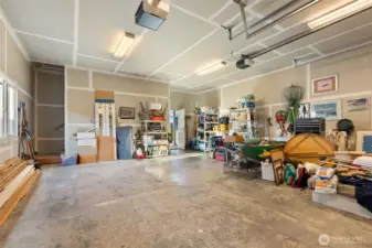 Spacious 2 car garage.  Note the hint of a staircase on the left- an upper unfinished area ready for your ideas.